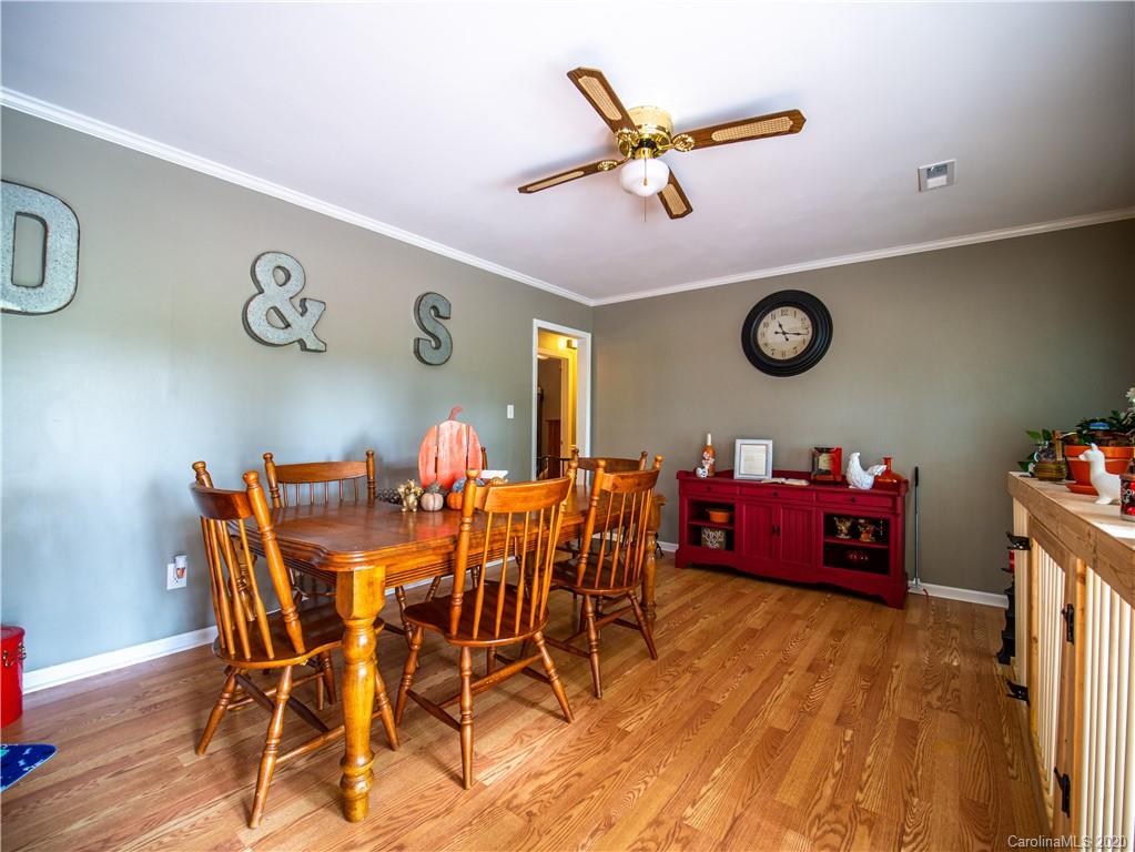 5610 Camp Creek Road Lancaster, SC 29720 - Photo 11 of 21 a view of a dining room with furniture and a clock