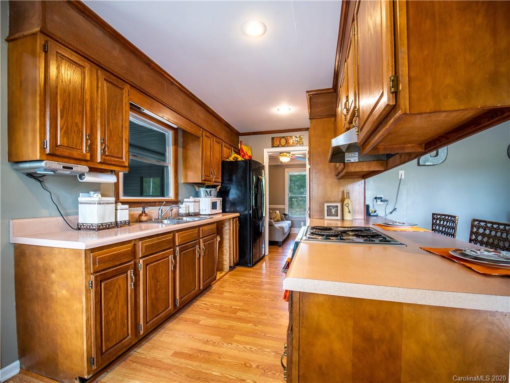 5610 Camp Creek Road Lancaster, SC 29720 - Photo 12 of 21 a kitchen with stainless steel appliances granite countertop a sink a stove and a wooden cabinets