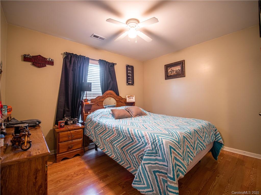 5610 Camp Creek Road Lancaster, SC 29720 - Photo 14 of 21 a bedroom with a bed and wooden floor