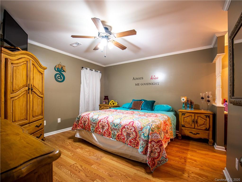 5610 Camp Creek Road Lancaster, SC 29720 - Photo 15 of 21 a bedroom with a bed and dresser with mirror