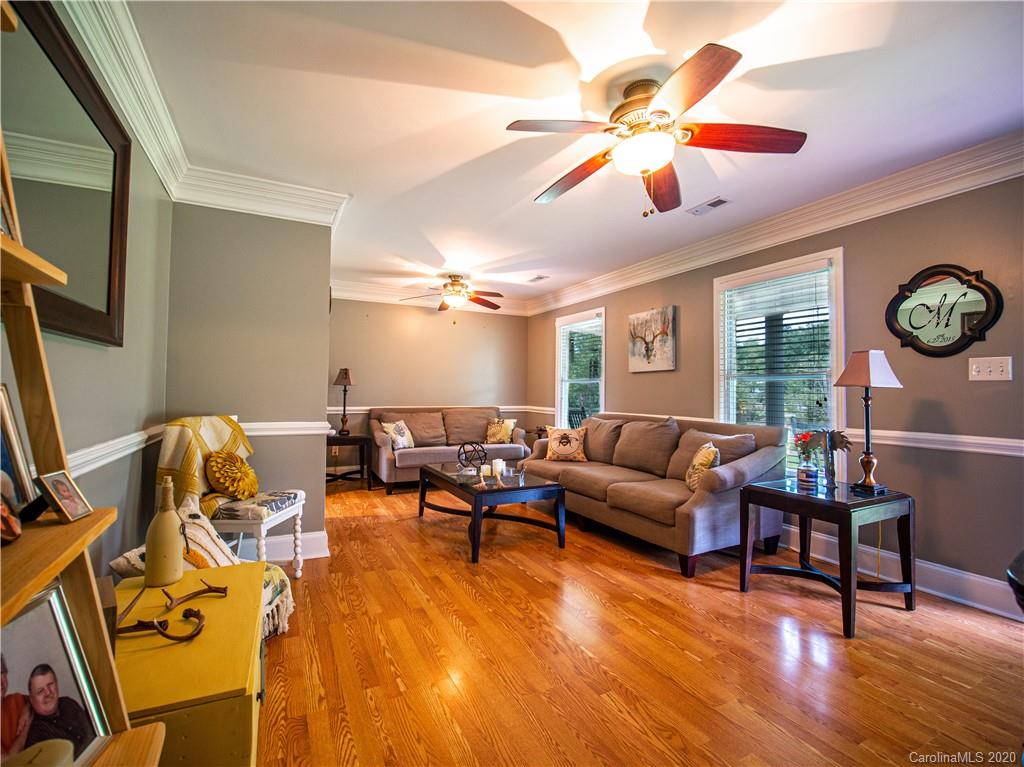 5610 Camp Creek Road Lancaster, SC 29720 - Photo 9 of 21 a living room with furniture a clock on wall and a window