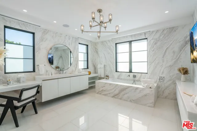 a view of a dining room with furniture a chandelier and wooden floor