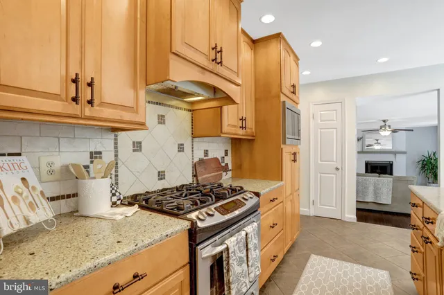 a kitchen with stainless steel appliances granite countertop a stove and a refrigerator