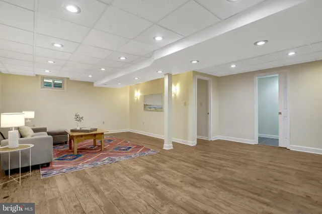 a view of a big room with furniture and wooden floor