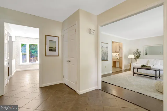 a living room with furniture and view of dining room