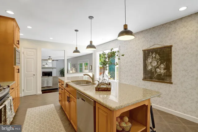 a kitchen with stainless steel appliances granite countertop a sink a stove and a refrigerator