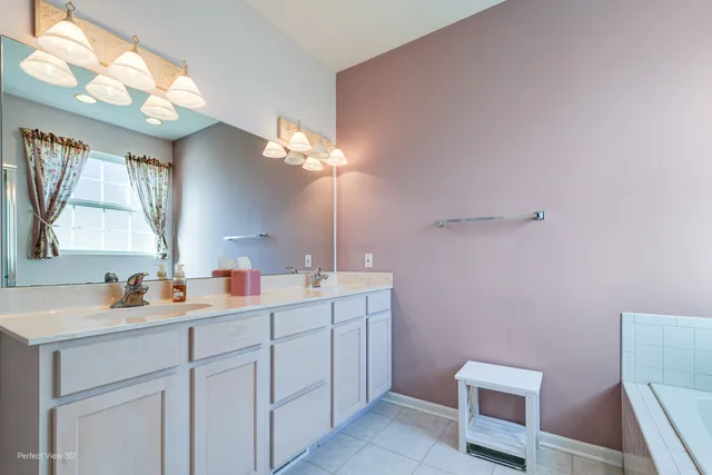 a bathroom with a sink vanity and mirror