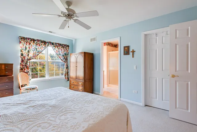 a bedroom with a bed dresser and a window