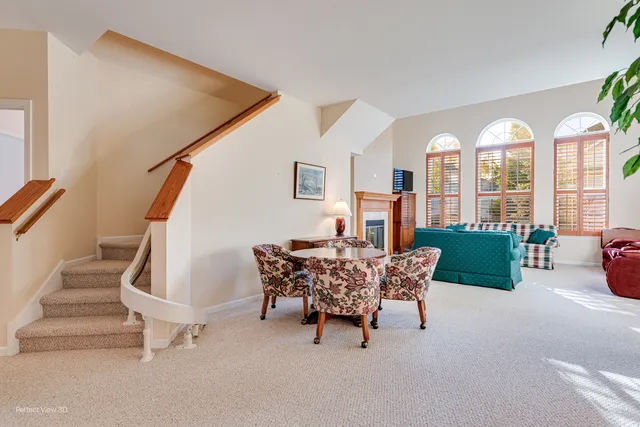 a dining room with furniture and a floor to ceiling window