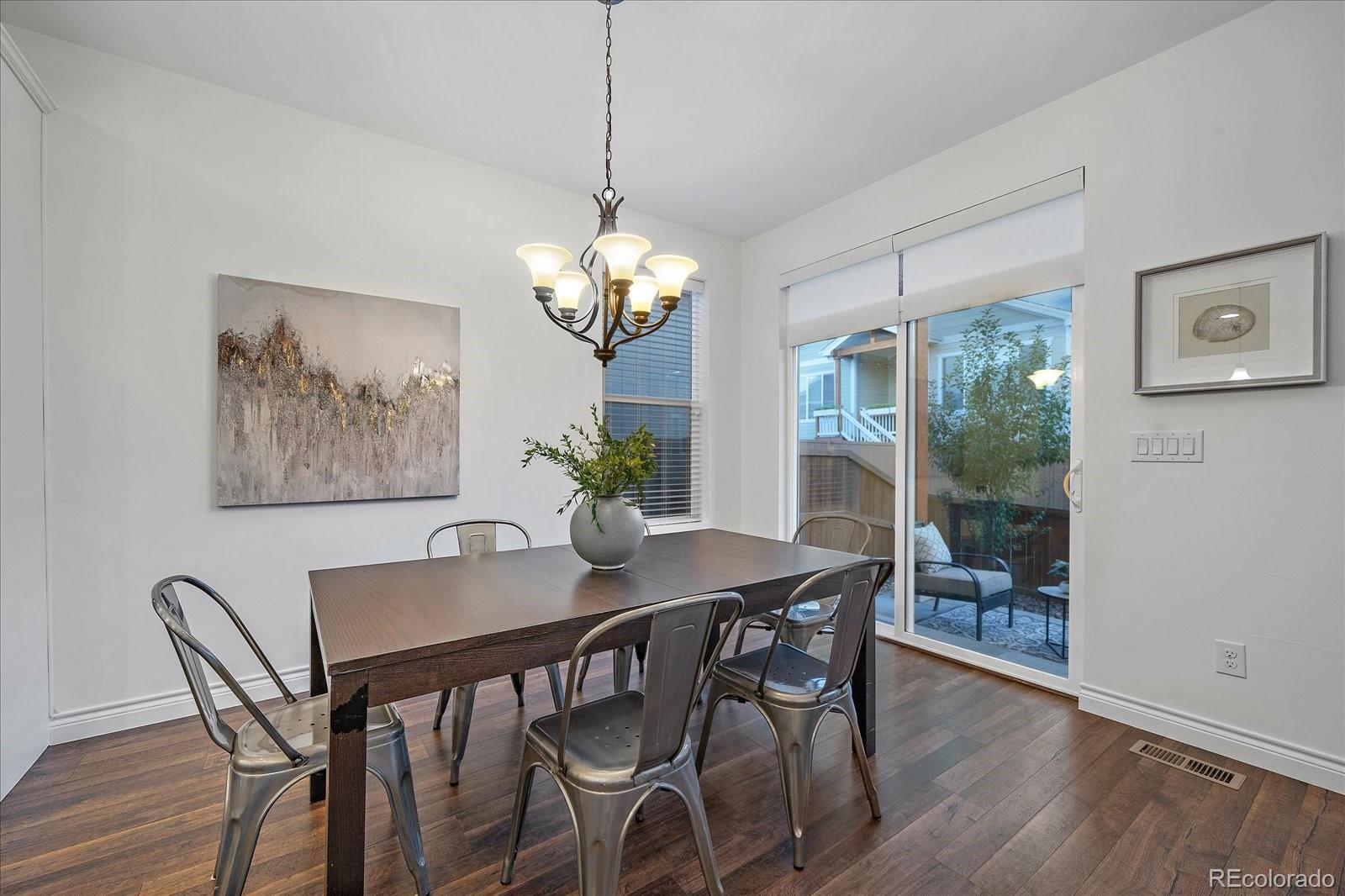 11526 Colony Loop Parker, CO 80138 - Photo 12 of 29 a view of a dining room with furniture wooden floor and a chandelier
