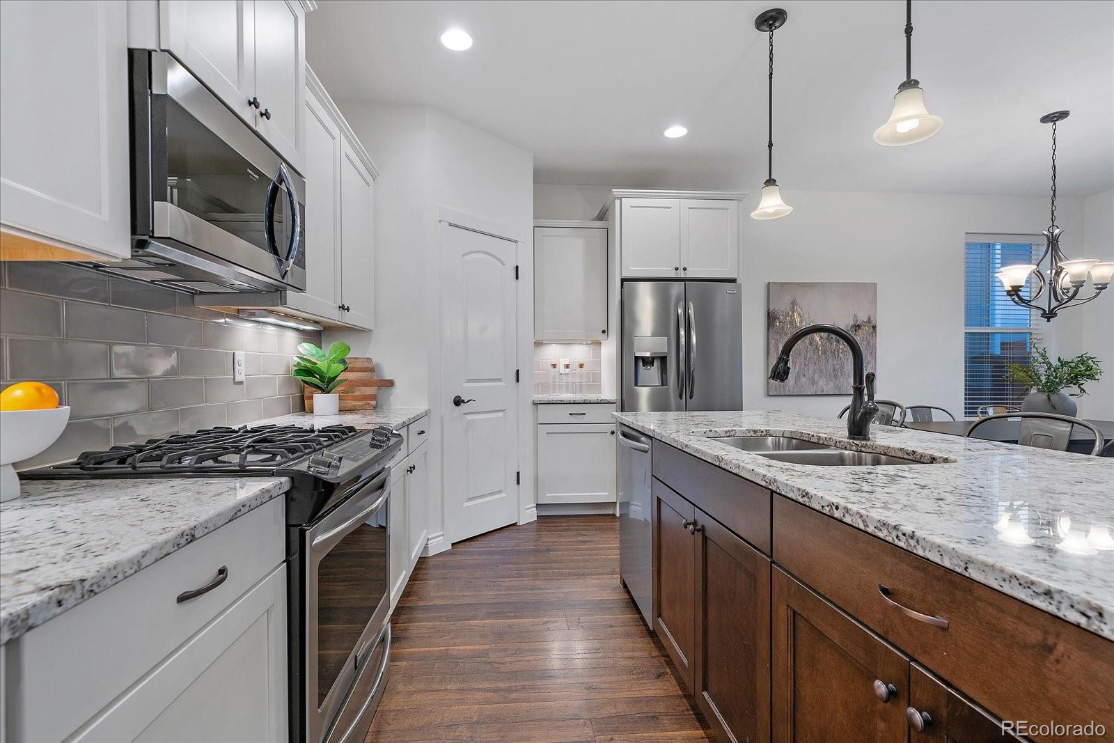 11526 Colony Loop Parker, CO 80138 - Photo 15 of 29 a kitchen with a sink stove and oven