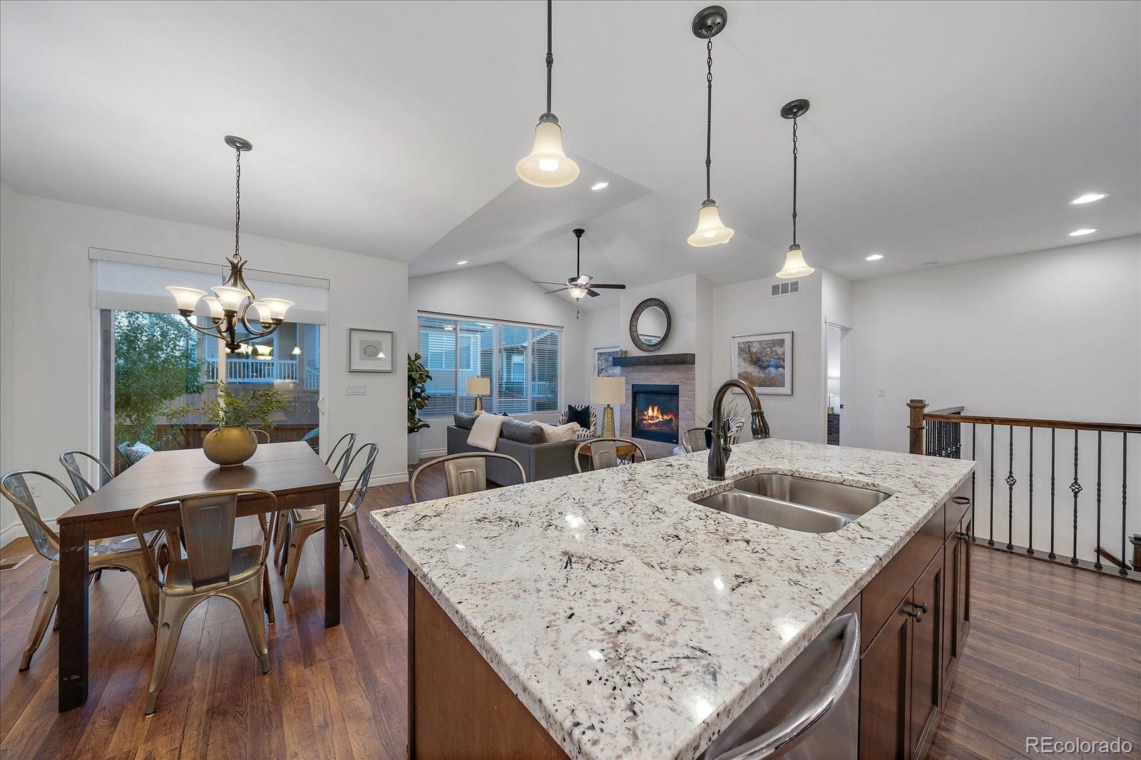 11526 Colony Loop Parker, CO 80138 - Photo 16 of 29 a view of a dining room and livingroom with furniture wooden floor a chandelier