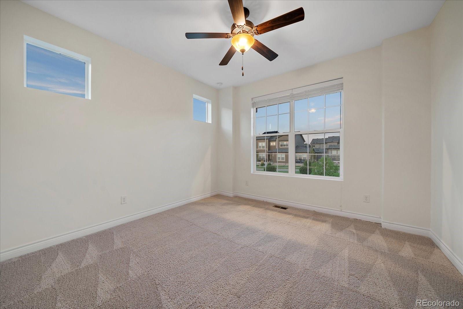 11526 Colony Loop Parker, CO 80138 - Photo 23 of 29 an empty room with windows and fan