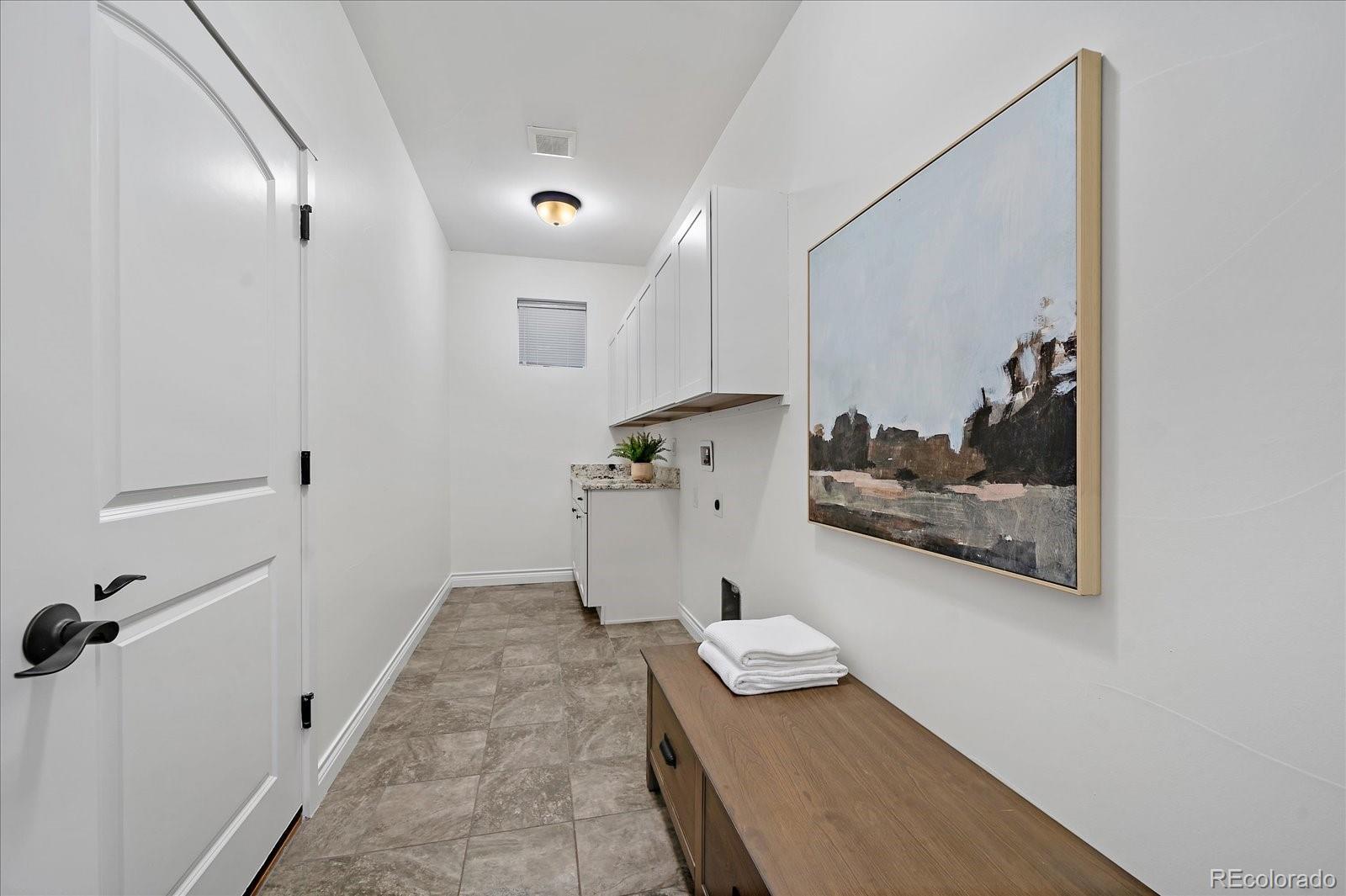 11526 Colony Loop Parker, CO 80138 - Photo 26 of 29 a view of a hallway with wooden floor and furniture