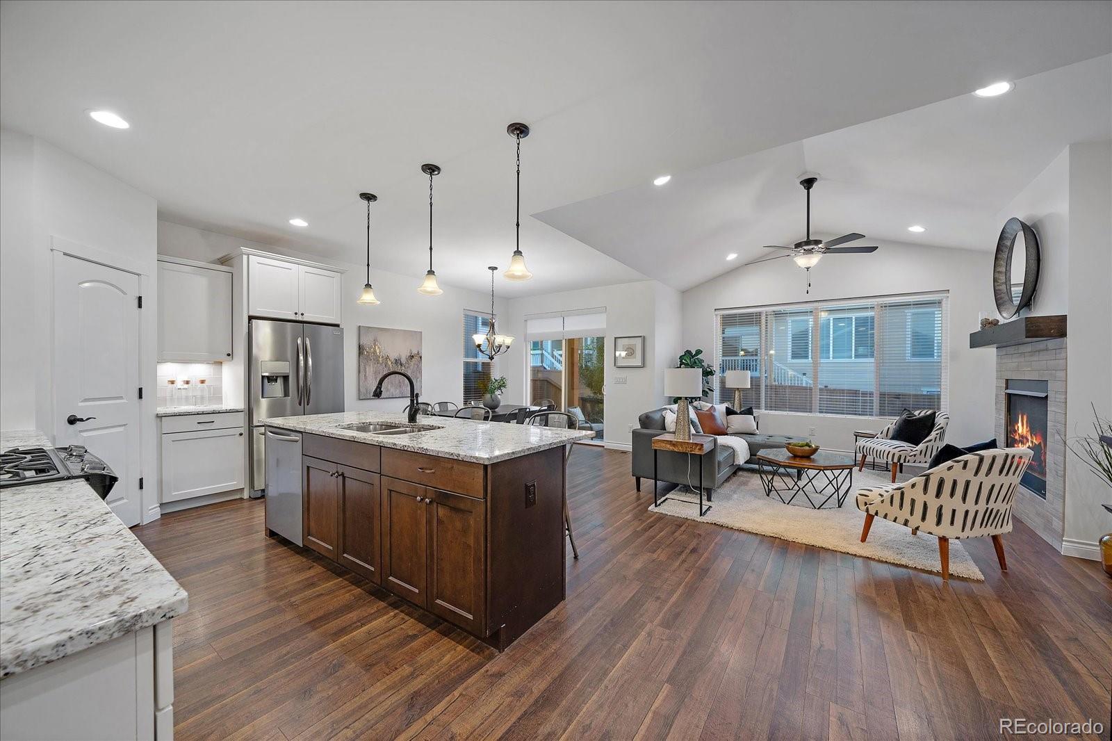 11526 Colony Loop Parker, CO 80138 - Photo 5 of 29 a large kitchen with stainless steel appliances granite countertop a lot of counter space and wooden floors