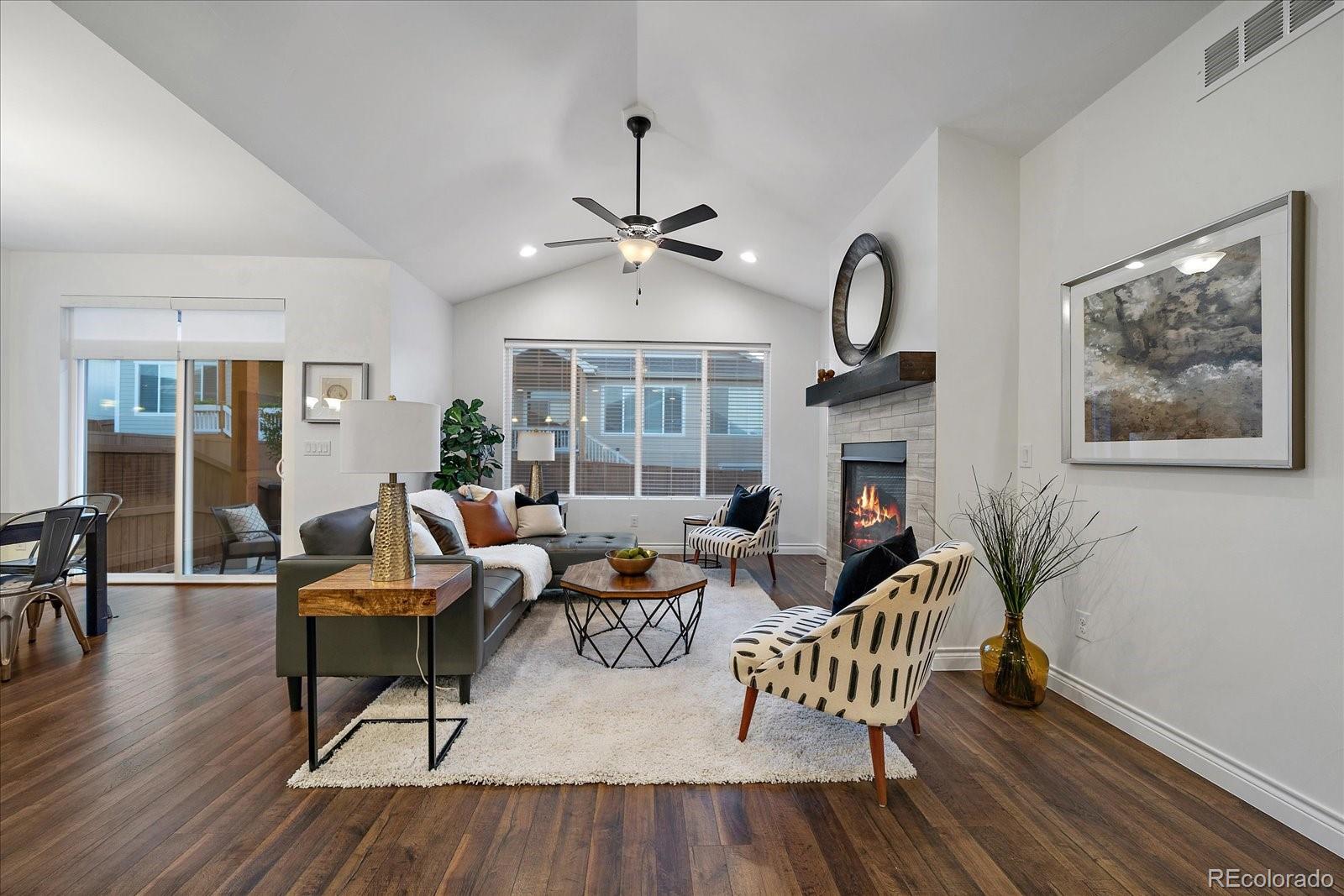 11526 Colony Loop Parker, CO 80138 - Photo 6 of 29 a living room with fireplace furniture and a wooden floor
