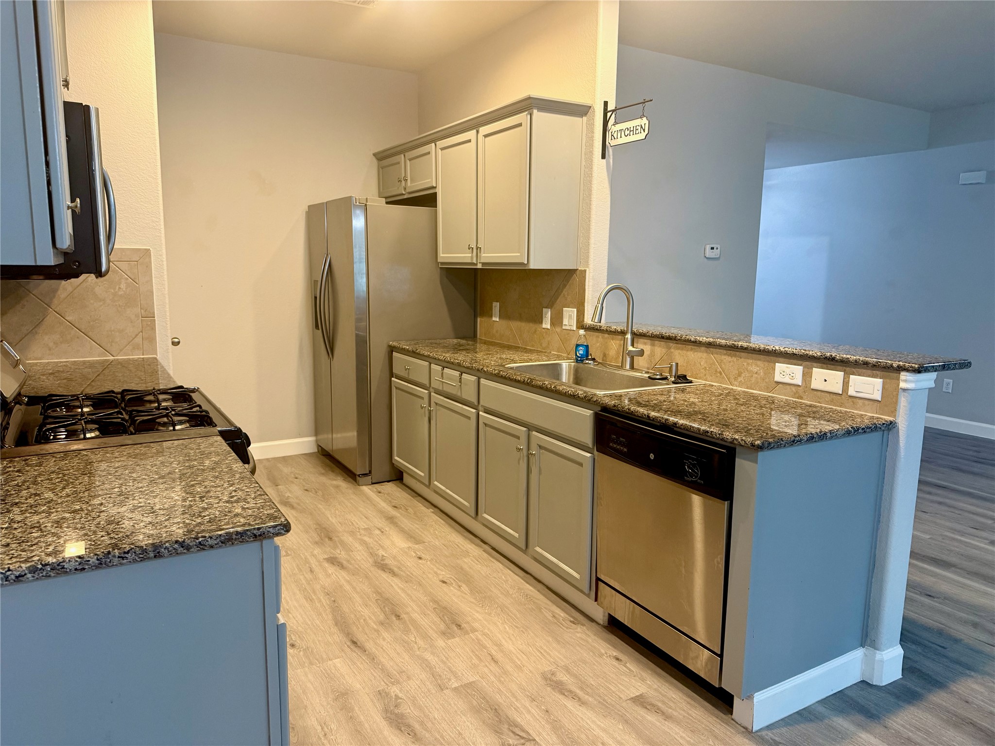315 Nottingham Loop Kyle, TX 78640 - Photo 4 of 16 A well-appointed kitchen features ample counter space, modern appliances, and a convenient breakfast bar.