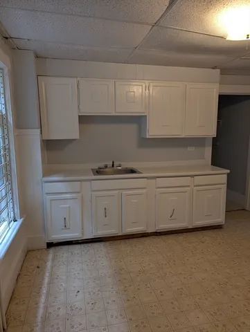 a kitchen with white cabinets and a stove