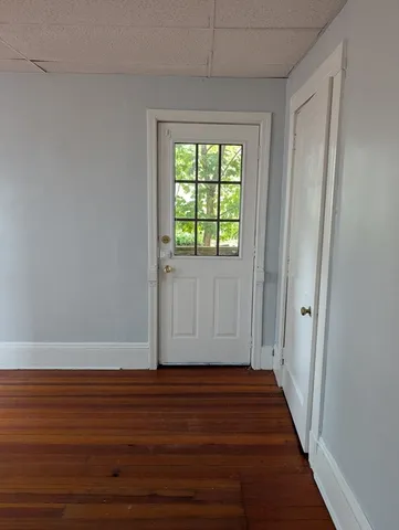 a view of a room with wooden floor and window