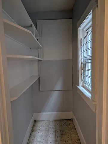a view of storage and utility room with a window