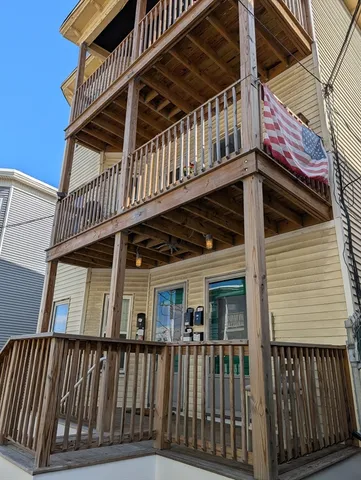 a view of deck with large trees and wooden floor