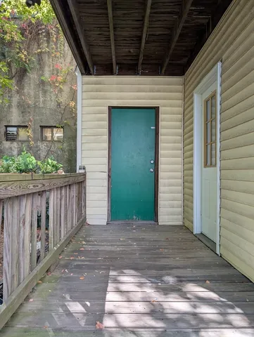 a view of a house with wooden deck