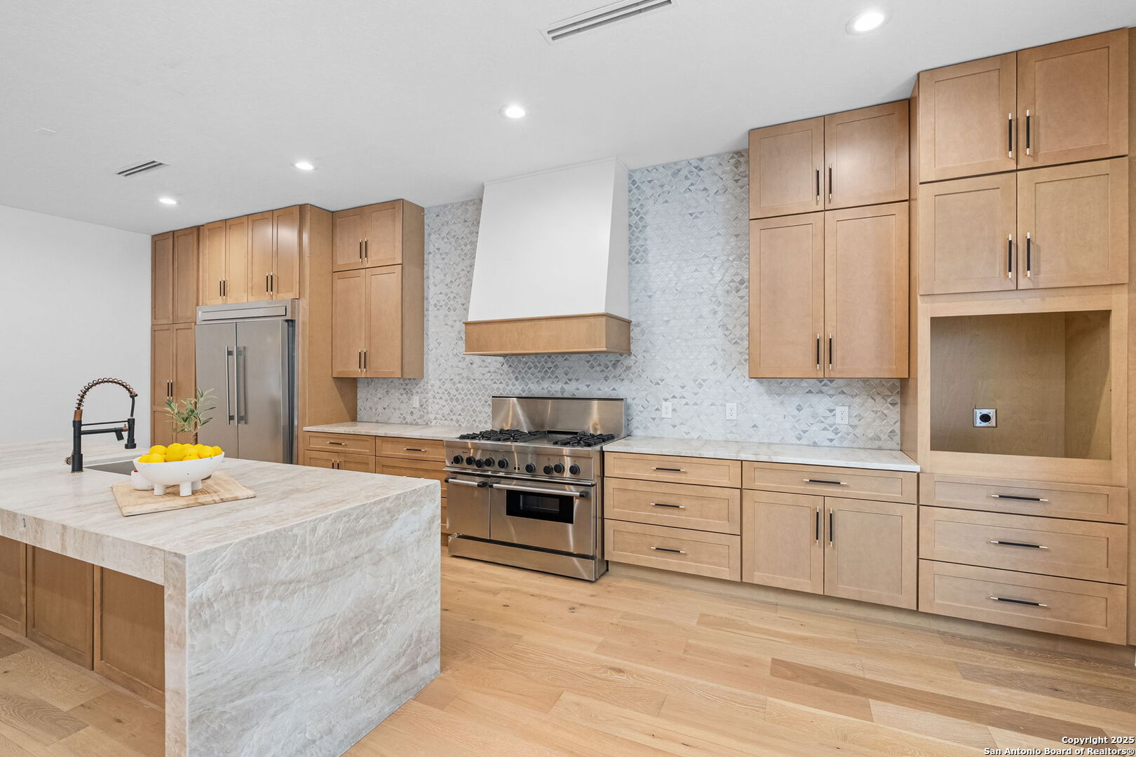 718 Ridgemont Avenue Terrell Hills, TX 78209 - Photo 16 of 39 a kitchen with stainless steel appliances granite countertop a stove a sink dishwasher and a refrigerator with white cabinets