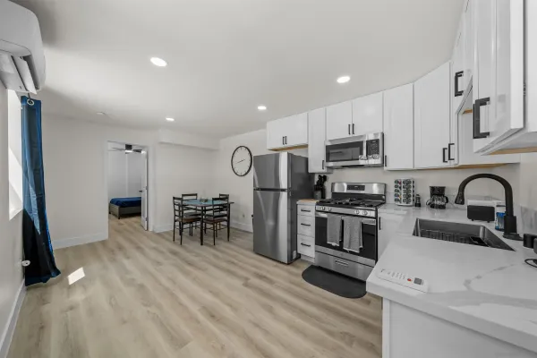a kitchen with stainless steel appliances a refrigerator stove microwave and sink