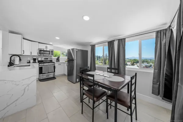 a kitchen with refrigerator cabinets and large window