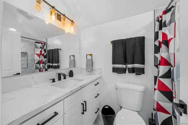 a bathroom with a tub sink toilet a mirror and shower