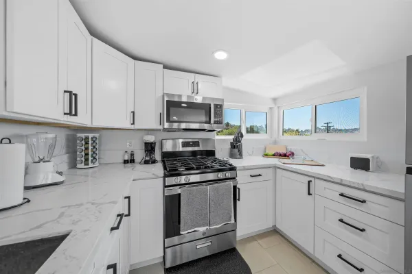 a kitchen with a sink and chairs
