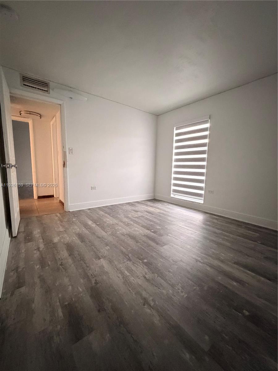 7250 Southwest 94th Place, Unit B8 Miami, FL 33173 - Photo 13 of 18 a view of empty room with wooden floor and fan