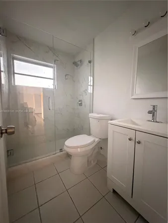 a white toilet sitting next to a bathroom sink