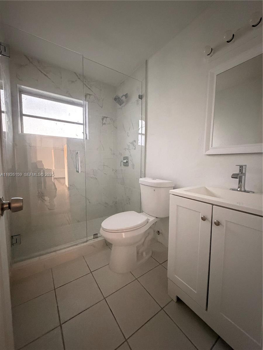 7250 Southwest 94th Place, Unit B8 Miami, FL 33173 - Photo 17 of 18 a white toilet sitting next to a bathroom sink