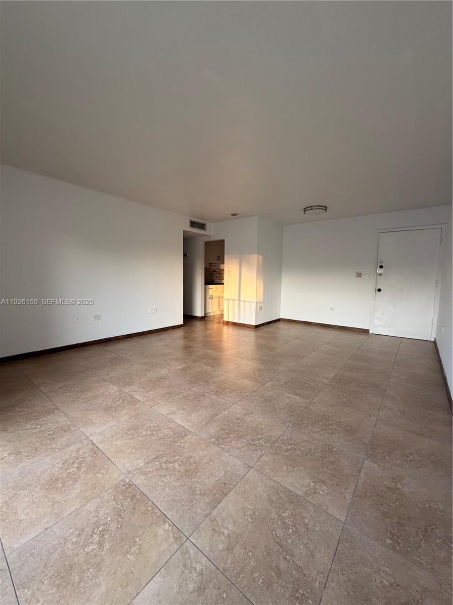 7250 Southwest 94th Place, Unit B8 Miami, FL 33173 - Photo 4 of 18 a view of an empty room with wooden floor