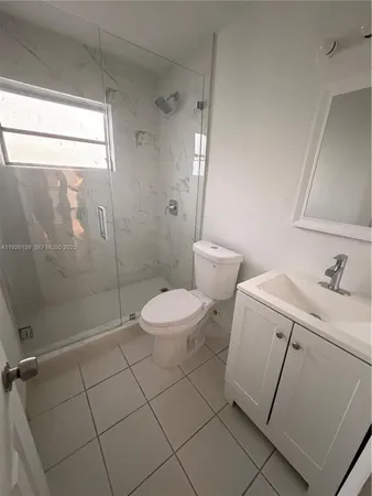 a bathroom with a toilet sink and shower