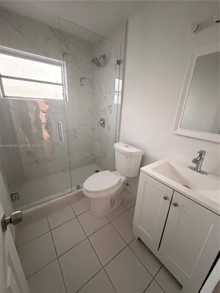 7250 Southwest 94th Place, Unit B8 Miami, FL 33173 - Photo 10 of 18 a bathroom with a toilet sink and shower