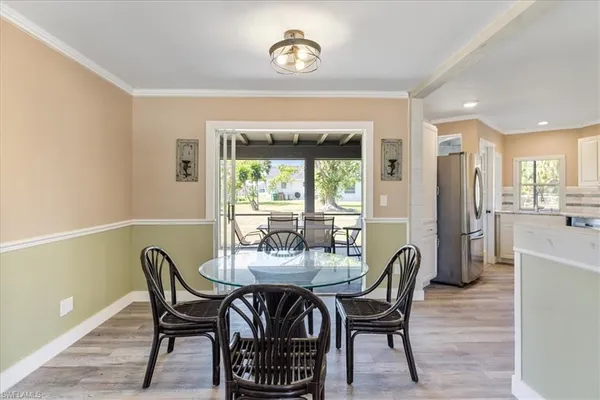 a dining room with furniture and a window