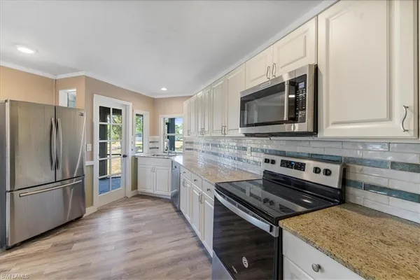 a kitchen with a refrigerator stove and microwave