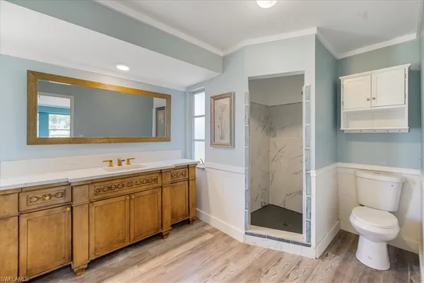 a bathroom with a toilet sink and shower