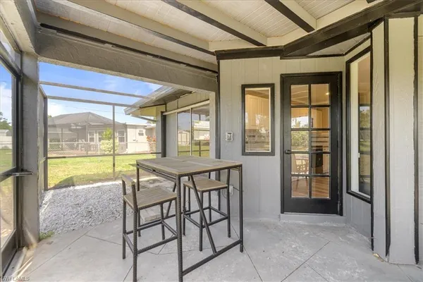 a view of a room that has a dining table and chairs