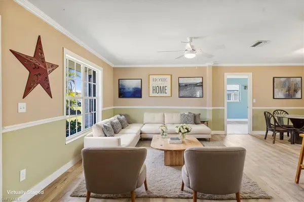 a living room with furniture a rug and a window