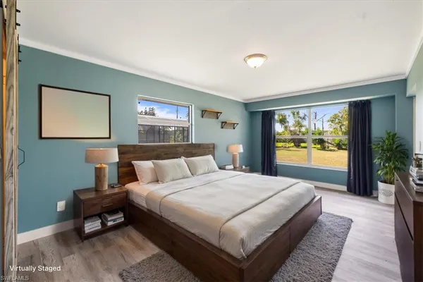 a spacious bedroom with a bed and a large window