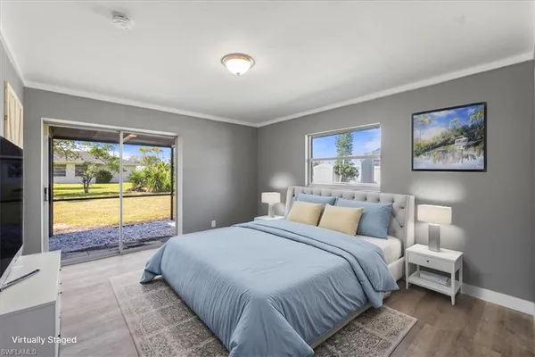 a bed room with a bed and a large window