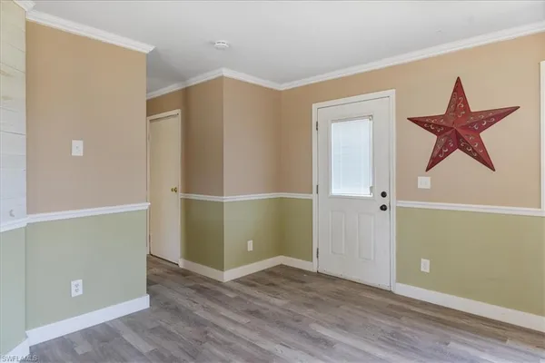 an empty room with wooden floor and closet