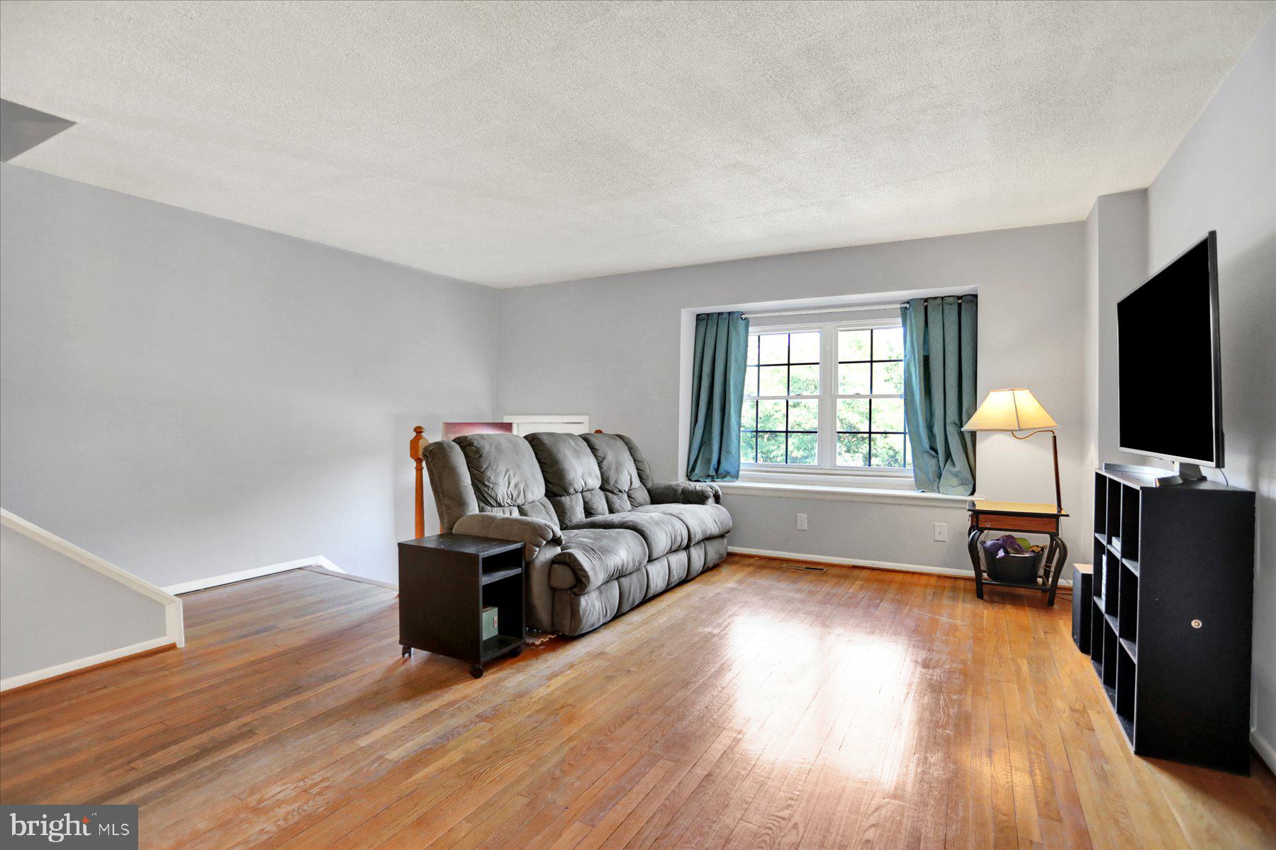 959 Elm Road Baltimore, MD 21227 - Photo 5 of 27 a living room with furniture and a flat screen tv