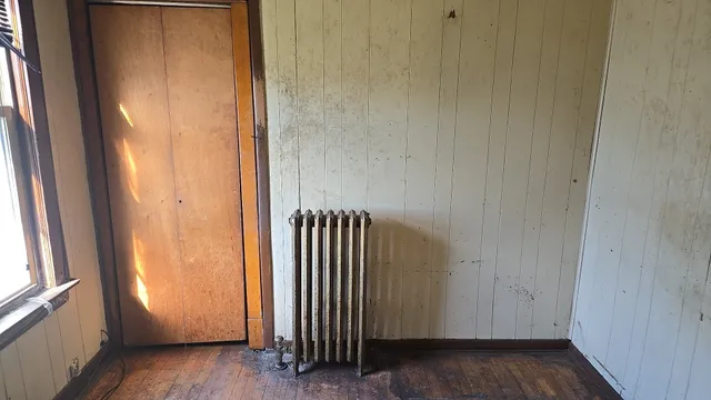 a view of a closet with wooden floor