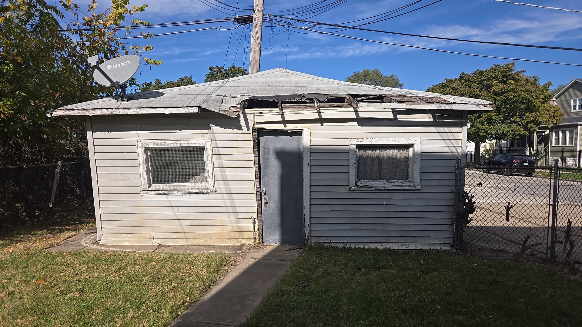 134 West 107th Street Chicago, IL 60628 - Photo 6 of 24 a view of a white house with a yard and potted plants
