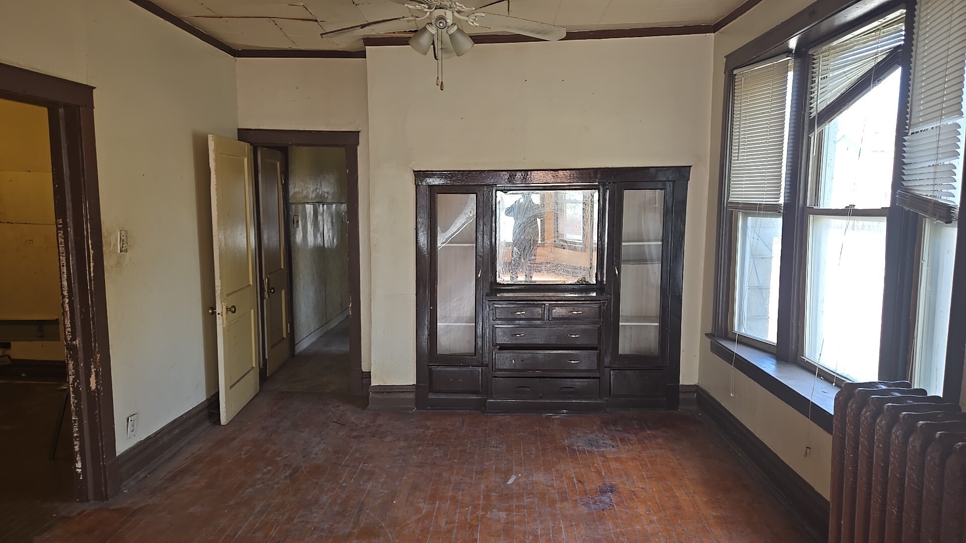 134 West 107th Street Chicago, IL 60628 - Photo 8 of 24 an empty room with windows and a ceiling fan