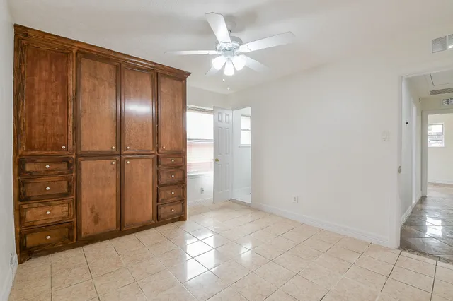 an empty room with closet and mirror